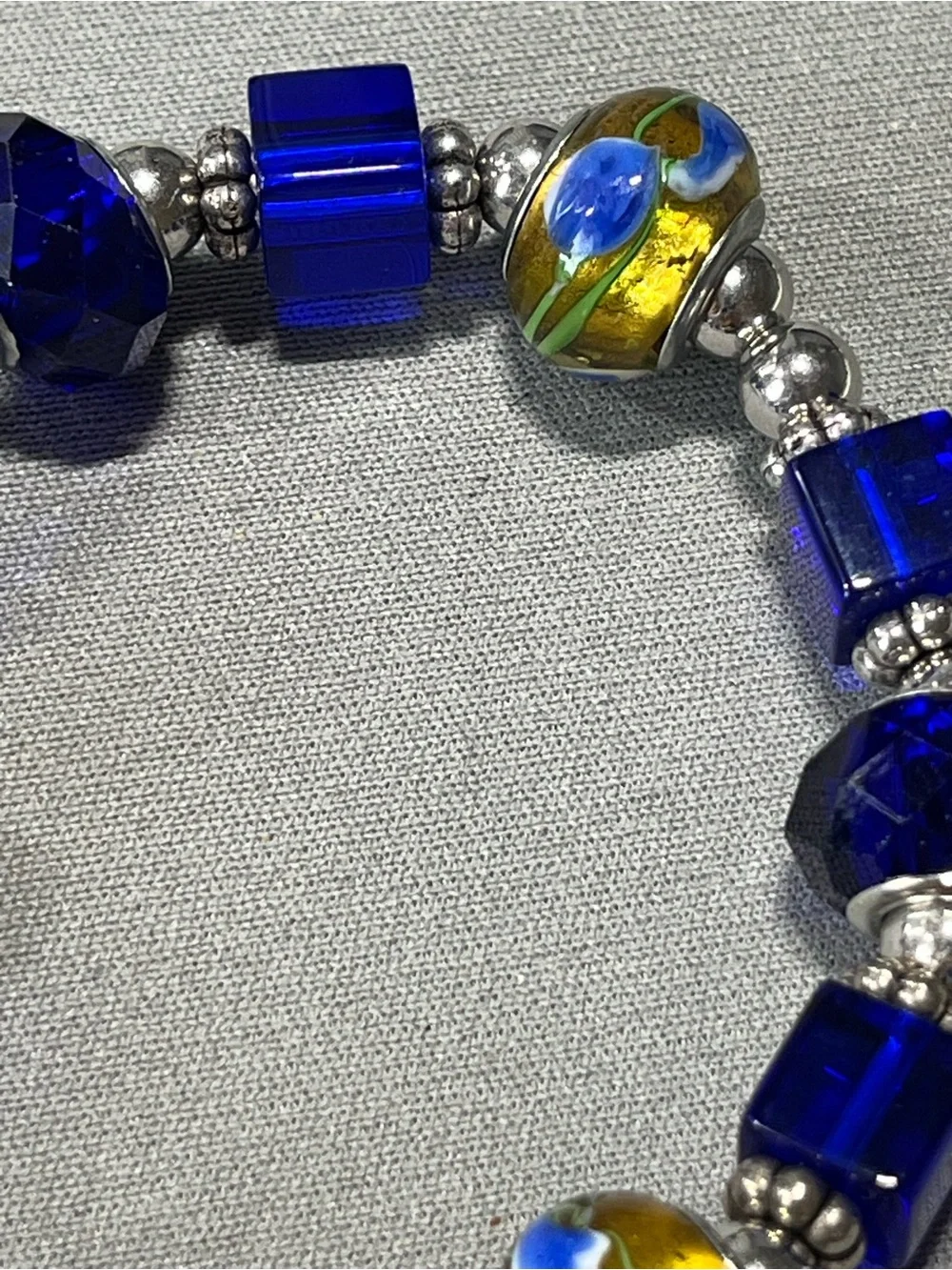 NWOT beautiful blue and yellow plastic beads with silver tone beads in between.